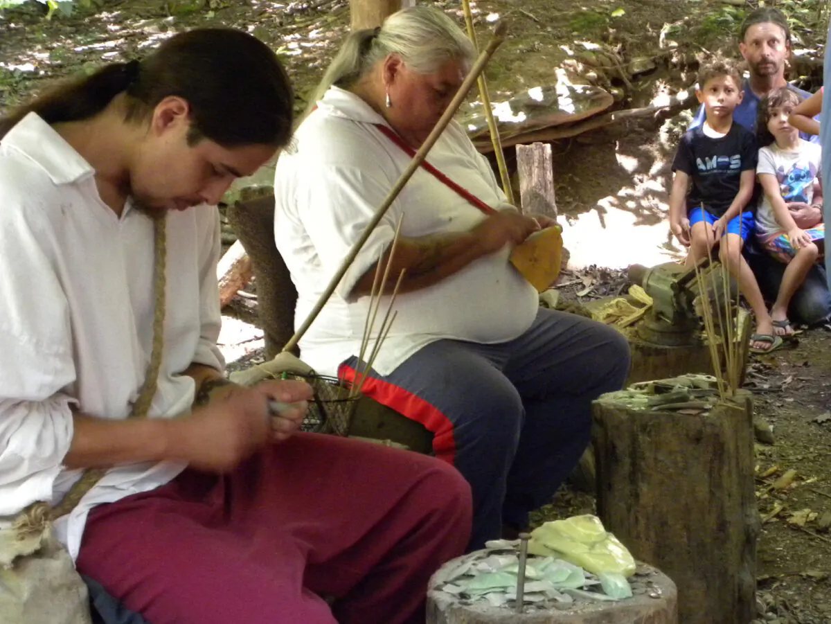 A family watches as members of the Cherokee Nation demonstrate the survival skills they still learn in Cherokee, North Carolina. (Bill Neely)
