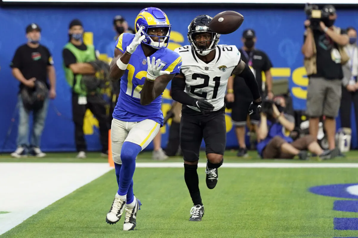 Los Angeles Rams wide receiver Van Jefferson (12) catches a touchdown in front of Jacksonville Jaguars cornerback Nevin Lawson (21) during the second half of an NFL football game in Inglewood, Calif., on Dec. 5, 2021. (Jae C. Hong/AP Photo)