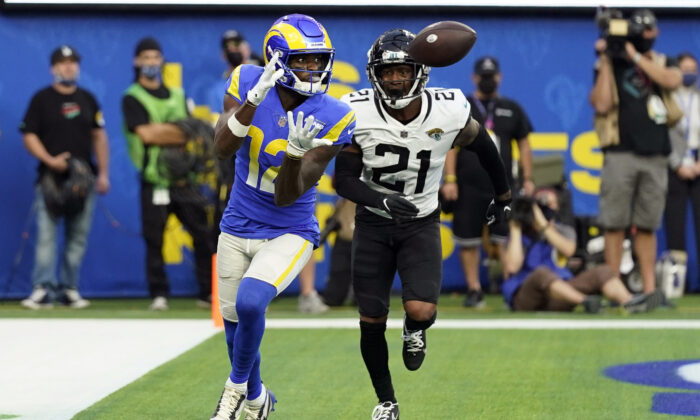 Los Angeles Rams wide receiver Van Jefferson (12) catches a touchdown in front of Jacksonville Jaguars cornerback Nevin Lawson (21) during the second half of an NFL football game in Inglewood, Calif., on Dec. 5, 2021. (Jae C. Hong/AP Photo)