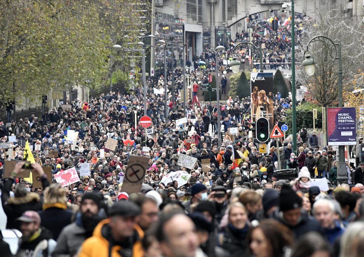 Demonstrators march during a protest against CCP virus measures in Brussels, Belgium, on Dec. 5, 2021. (Geert Vanden Wijngaert/AP Photo)