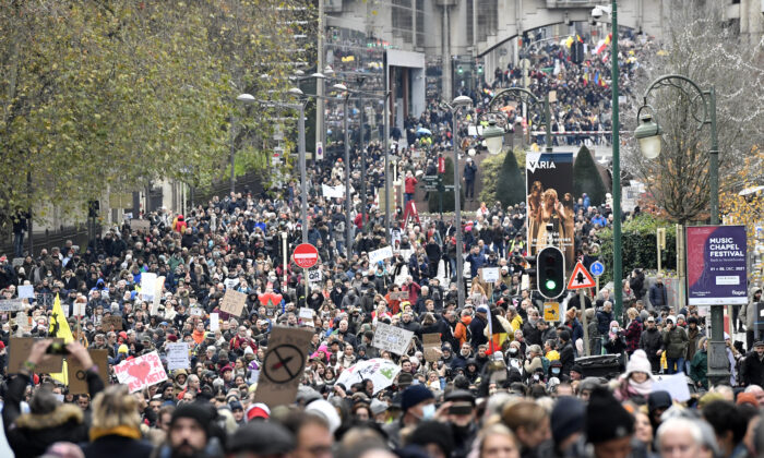 Demonstrators march during a protest against CCP virus measures in Brussels, Belgium, on Dec. 5, 2021. (Geert Vanden Wijngaert/AP Photo)