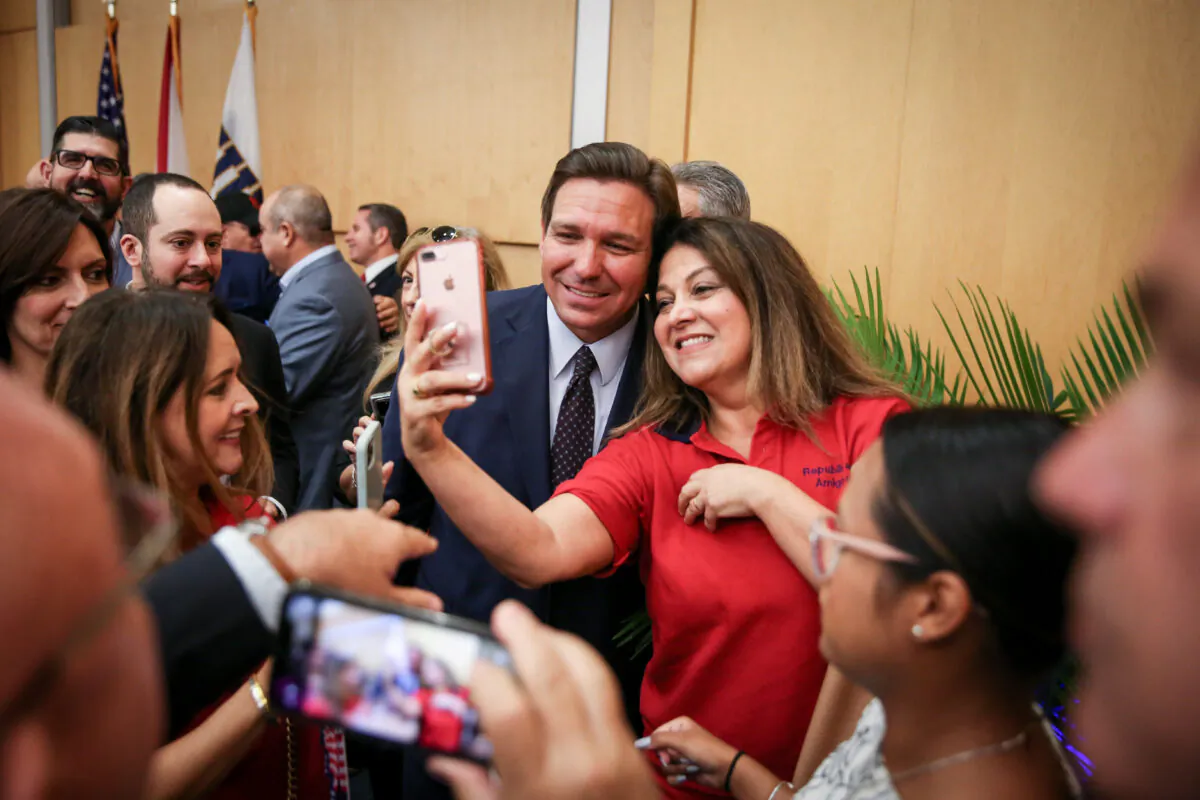 Florida Gov. Ron DeSantis mingles with audience members after signing into law Senate Bill 7072 at Florida International University in Miami on May 24, 2021. (Samira Bouaou/The Epoch Times)