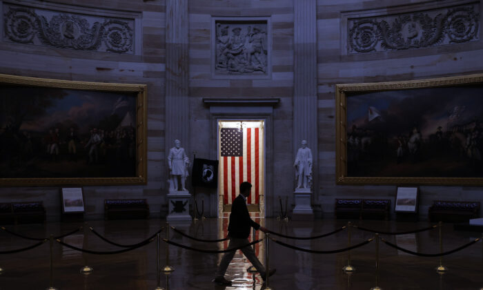 A man walks through the U.S. Capitol Rotunda, empty of tourists as only essential staff and journalists are allowed to work during the coronavirus pandemic March 24, 2020. (Chip Somodevilla/Getty Images)