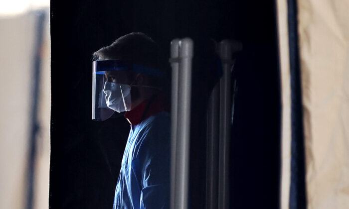 Health care professionals prepare to screen people for the coronavirus at a testing site in Landover, Maryland, on March 30, 2020. (Chip Somodevilla/Getty Images)
