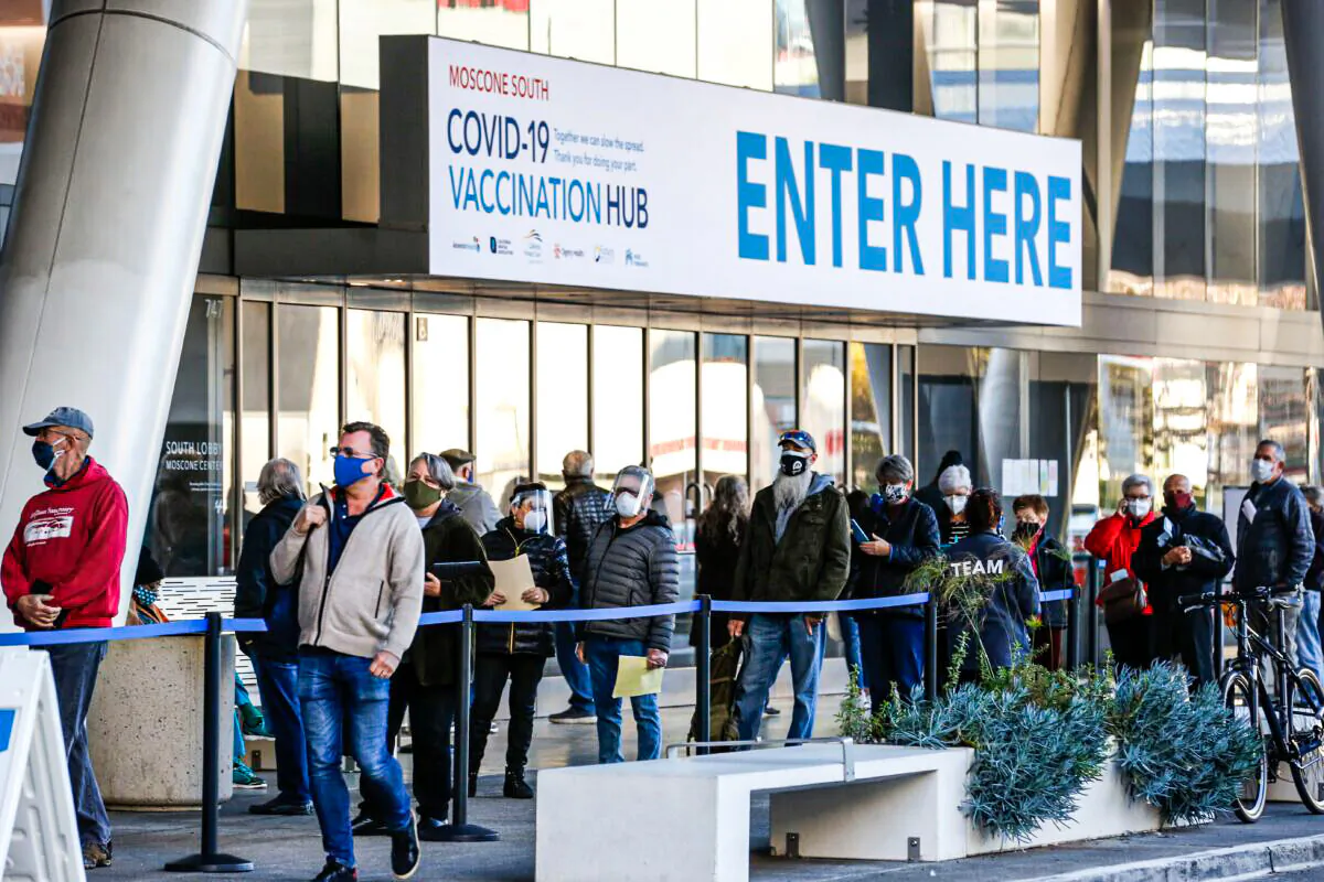 People stand in line at a mass vaccination site located at the Moscone Convention Center on Feb. 5, 2021 in San Francisco, Calif. (Amy Osborne/AFP via Getty Images)