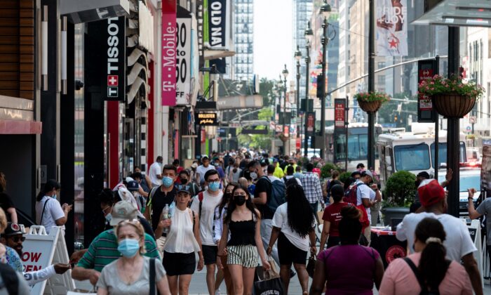 People walk through a shopping area in Manhattan in New York City on Jun. 7, 2021. (Angela Weiss/Getty Images)