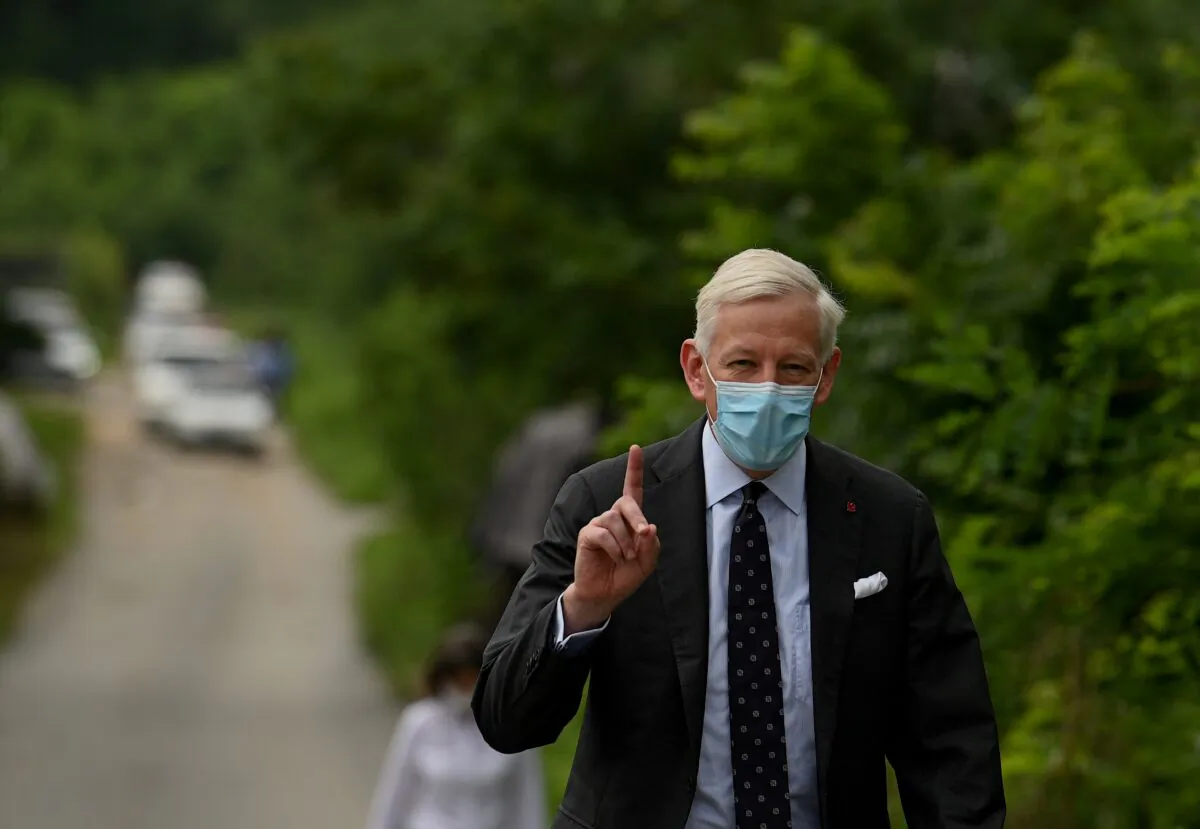 Then-Canadian Ambassador Dominic Barton walks outside the Dandong city detention centre where Canadian citizen Michael Spavor was held, in Dandong, Liaoning Province, China, on Aug. 11, 2021. (Noel Celis/AFP via Getty Images)