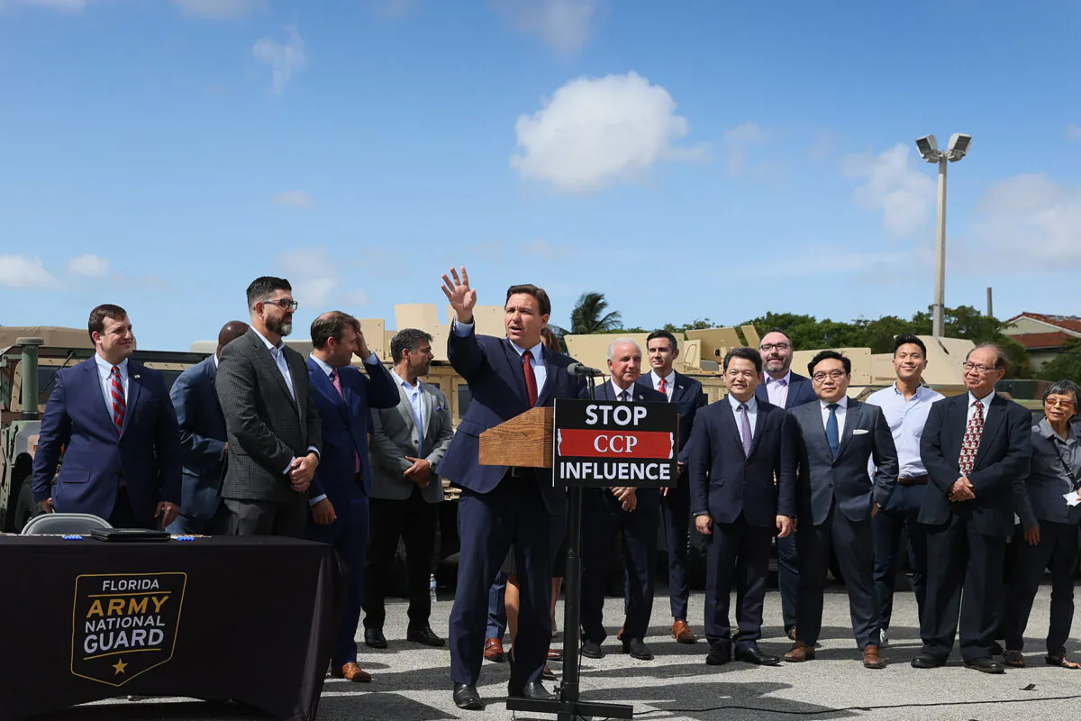 Florida Gov. Ron DeSantis signs two bills surrounded by state, local, and Taiwanese representatives at the Florida National Guard Robert A. Ballard Armory in Miami, Florida, on June 7, 2021. The governor signed the bills to combat foreign influence and corporate espionage in Florida from governments like China. (Joe Raedle/Getty Images)