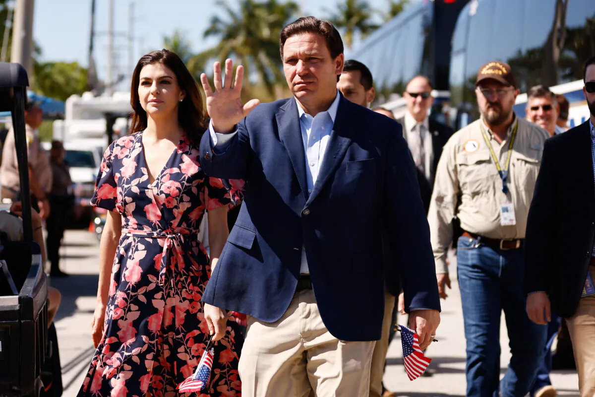 Florida Gov. Ron DeSantis and his wife, Casey, arrive to visit a memorial to those missing outside the 12-story Champlain Towers South condo building that partially collapsed on July 03, 2021 in Surfside, Florida. Over one hundred people are being reported as missing as the search-and-rescue effort continues. (Photo by Michael Reaves/Getty Images)