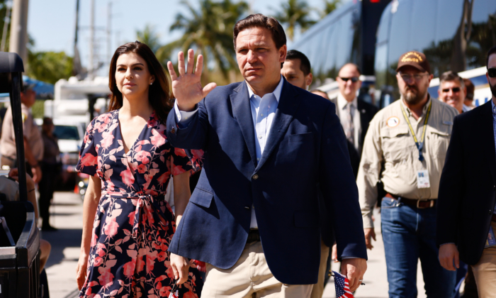 Florida Gov. Ron DeSantis and his wife, Casey, arrive to visit a memorial to those missing outside the 12-story Champlain Towers South condo building that partially collapsed on July 03, 2021 in Surfside, Florida. Over one hundred people are being reported as missing as the search-and-rescue effort continues. (Photo by Michael Reaves/Getty Images)