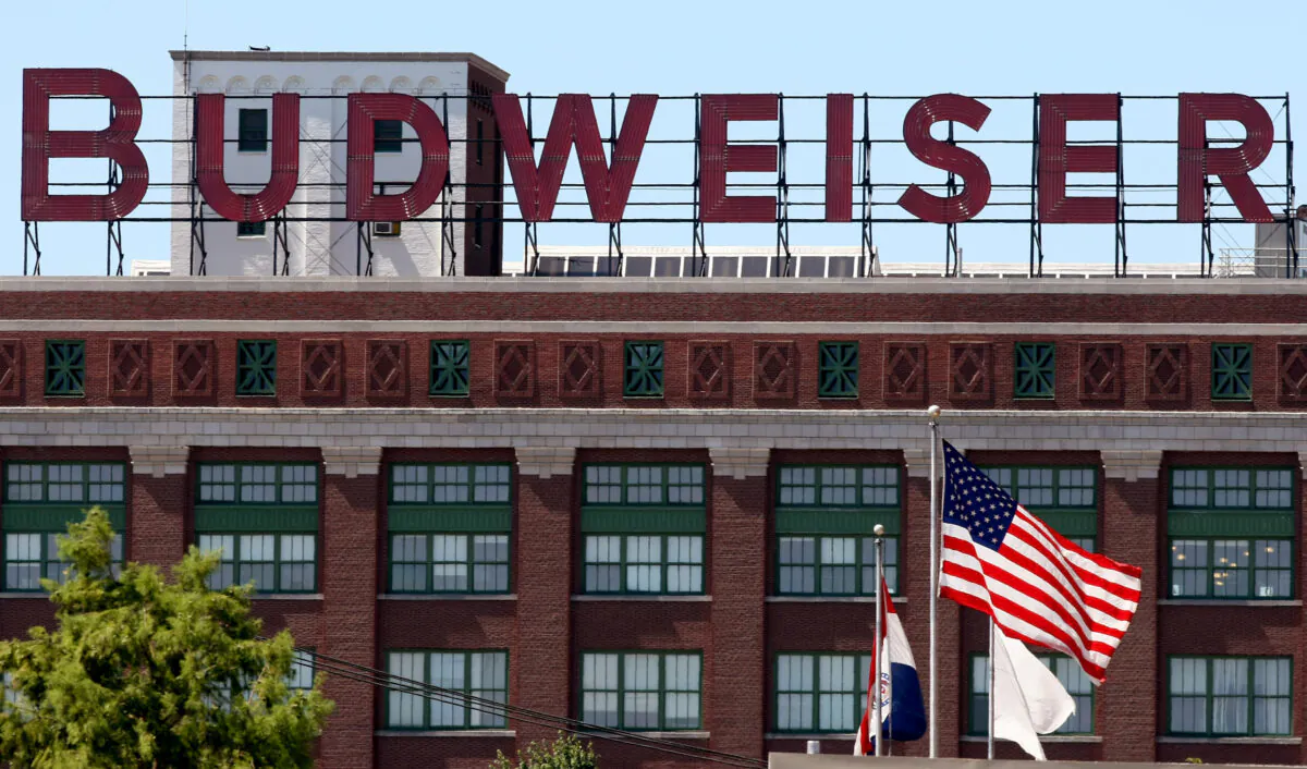 Flags fly in front of the packaging plant for Anheuser-Busch Cos. in St. Louis on July 14, 2008. (Whitney Curtis/Getty Images)