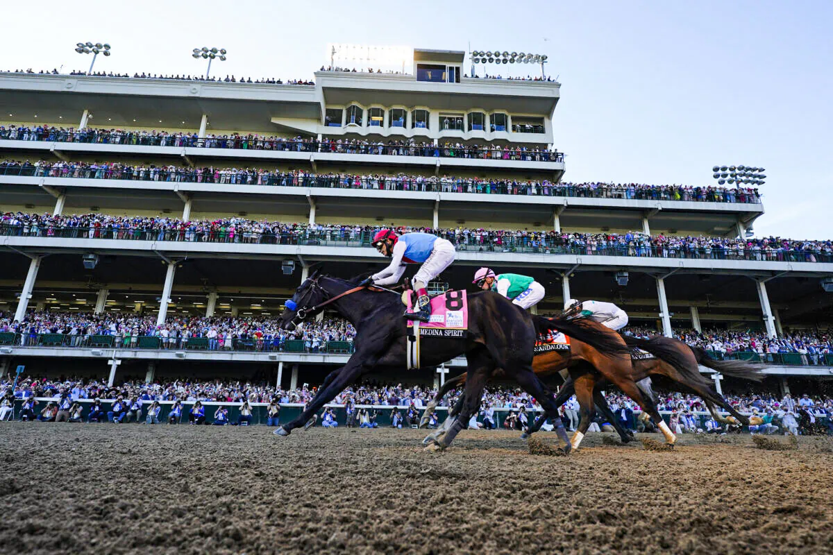 John Velazquez riding Medina Spirit leads Florent Geroux on Mandaloun and Flavien Prat riding Hot Rod Charlie to win the 147th running of the Kentucky Derby at Churchill Downs in Louisville, Ky., on May 1, 2021. (Jeff Roberson/AP Photo)