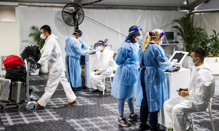 Travelers receive COVID-19 tests at a pre-departure testing facility, as countries react to the new Omicron variant, outside the international terminal at Sydney Airport in Australia, on Nov. 29, 2021. (Loren Elliott/Reuters)