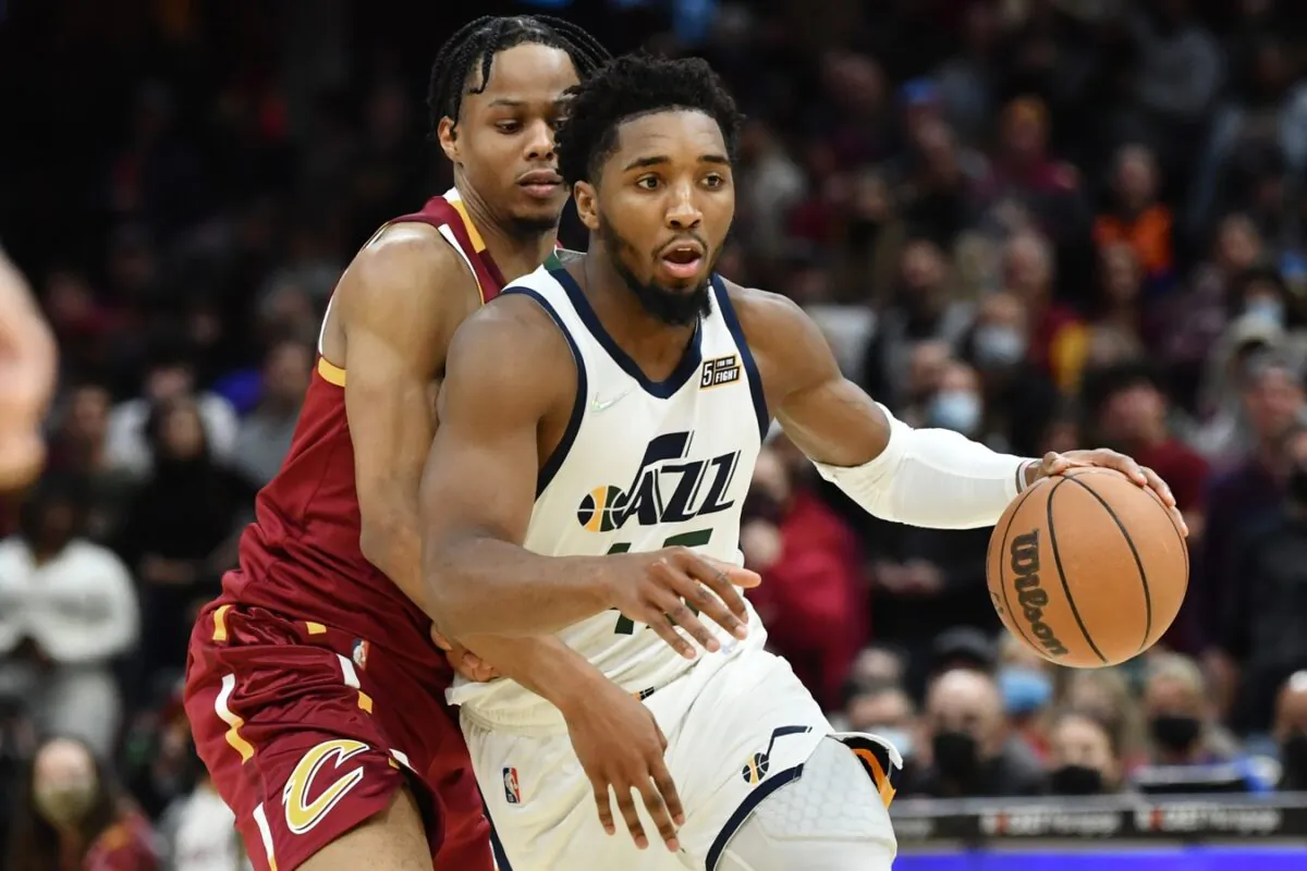 Utah Jazz guard Donovan Mitchell (45) drives to the basket against Cleveland Cavaliers forward Isaac Okoro during an NBA game in Cleveland, Ohio, on Dec. 5, 2021. (Ken Blaze/USA TODAY Sports via Field Level Media)