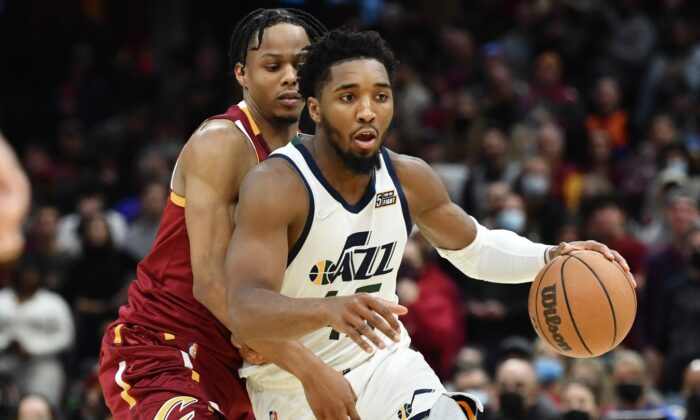 Utah Jazz guard Donovan Mitchell (45) drives to the basket against Cleveland Cavaliers forward Isaac Okoro during an NBA game in Cleveland, Ohio, on Dec. 5, 2021. (Ken Blaze/USA TODAY Sports via Field Level Media)