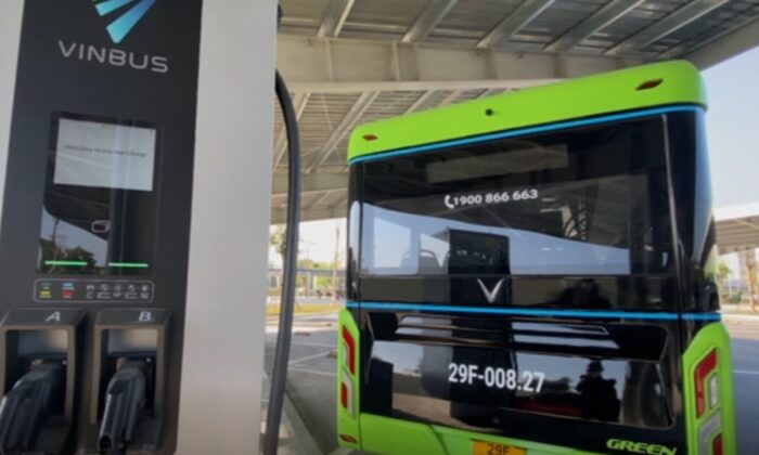 An electric bus parks next to a charging post in Hanoi, Vietnam, on Dec. 2, 2021, in a still from video. (AP/Screenshot via The Epoch Times)