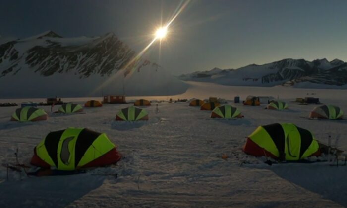 View of solar eclipse as tents camp in snow, in Antartica, on Dec. 4, 2021, in a still image from real-time camera footage released by AP. (Chile Air Force via AP/ Screenshot via The Epoch Times)