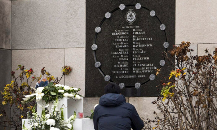 A man pays his respects at the memorial plaque at Ecole Polytechnique on Dec. 6, 2011, the 22nd anniversary of the Montreal massacre. The Dec. 6, 1989, massacre is still creating sharp political divisions on Parliament Hill over the nature of the crime and the proper response to it. (The Canadian Press/Ryan Remiorz)
