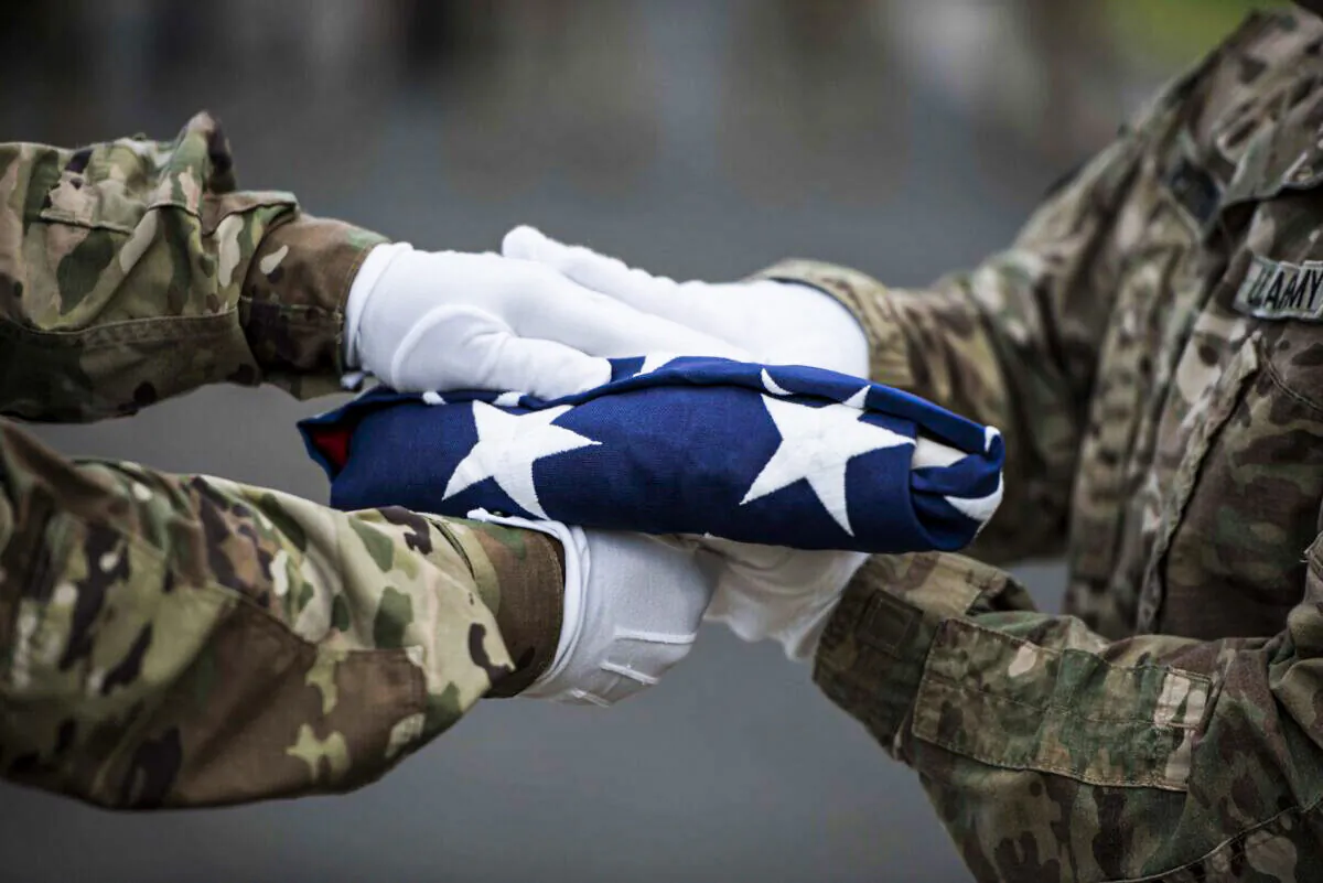 US soldiers with the Defense POW/MIA Accounting Agency (DPAA) transfer colors during a disinterment ceremony at the National Memorial Cemetery of the Pacific, Honolulu, Hawaii, April 3, 2017. (U.S. Marine Corps photo by Sgt. Lauren Falk)