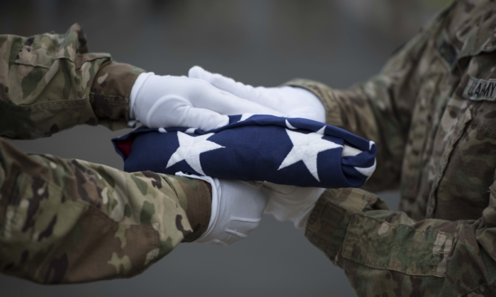 U.S. Soldiers with the Defense POW/MIA Accounting Agency (DPAA) transfer colors during a disinterment ceremony at the National Memorial Cemetery of the Pacific, Honolulu, Hawaii, April 3, 2017.  remains will be transferred to the DPAA laboratory for analysis and identification. DPAA's mission is to provide the fullest possible accounting for our missing personnel to their families and the nation. (U.S. Marine Corps photo by Sgt. Lauren Falk)