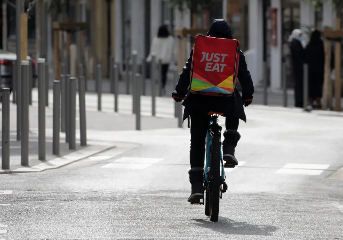A Just Eat delivery man rides his bicycle in Nice, France, on Feb. 16, 2021. (Eric Gaillard/Reuters)