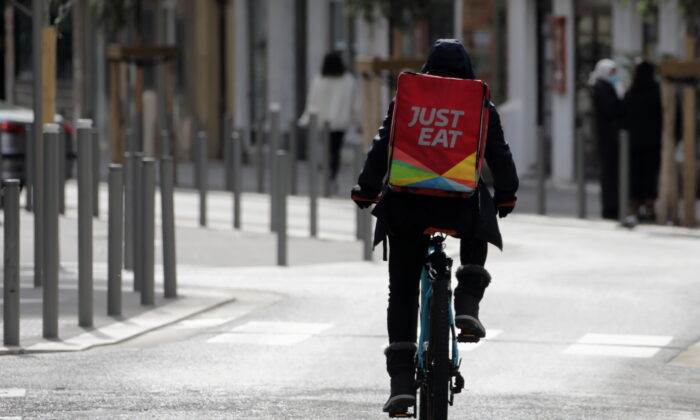 A Just Eat delivery man rides his bicycle in Nice, France, on Feb. 16, 2021. (Eric Gaillard/Reuters)