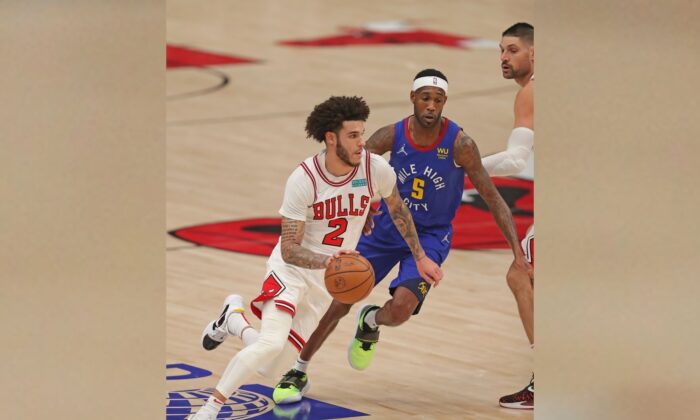 Chicago Bulls guard Lonzo Ball (2) drives around Denver Nuggets forward Will Barton during an NBA game at the United Center, in Chicago, Ill., on Dec. 6, 2021. (Dennis Wierzbicki/USA TODAY Sports via Field Level Media)