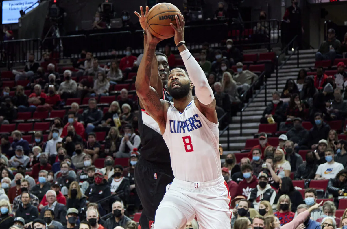 Los Angeles Clippers forward Marcus Morris Sr., right, shoots in front of Portland Trail Blazers forward Tony Snell during the first half of an NBA basketball game in Portland, Ore., on Dec. 6, 2021. (AP Photo/Craig Mitchelldyer)