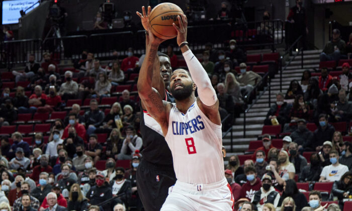 Los Angeles Clippers forward Marcus Morris Sr., right, shoots in front of Portland Trail Blazers forward Tony Snell during the first half of an NBA basketball game in Portland, Ore., on Dec. 6, 2021. (AP Photo/Craig Mitchelldyer)