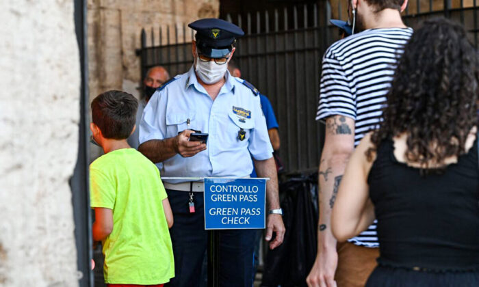 Visitors show their COVID-19 certificates scanned before entering the Ancient Colosseum in central Rome on Aug. 6, 2021. (Andreas Solaro/AFP via Getty Images)