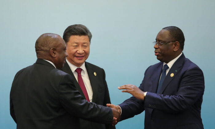South African President Cyril Ramaphosa (L) shakes hands with Senegalese President Macky Sall (R) as Chinese Leader Xi Jingping (C) looks on during 2018 Beijing Summit Of The Forum On China-Africa Cooperation Joint Press Conference in Beijing, China, on Sept. 4, 2018. (Lintao Zhang/Pool/Getty Images)