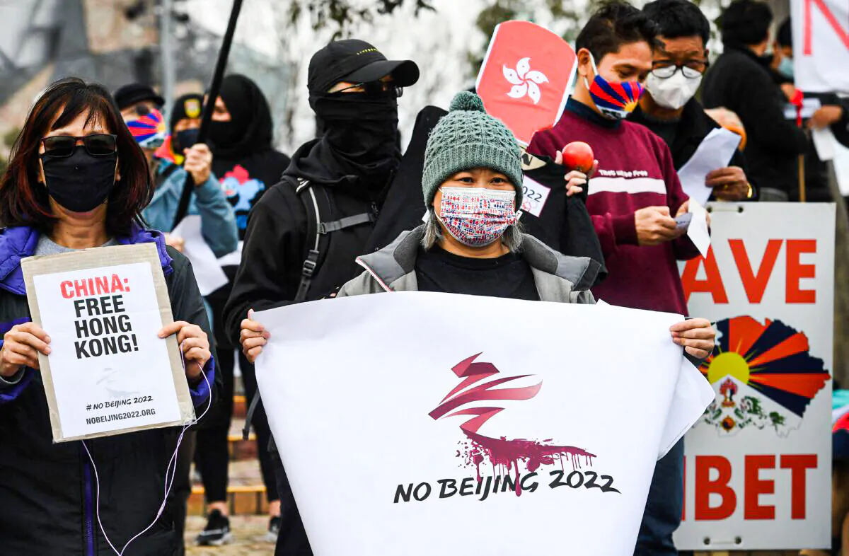 Activists including members of the local Hong Kong, Tibetan, and Uyghur communities hold up banners and placards in Melbourne on June 23, 2021, calling on the Australian government to boycott the 2022 Beijing Winter Olympics over China's human rights record. (William West/AFP via Getty Images)
