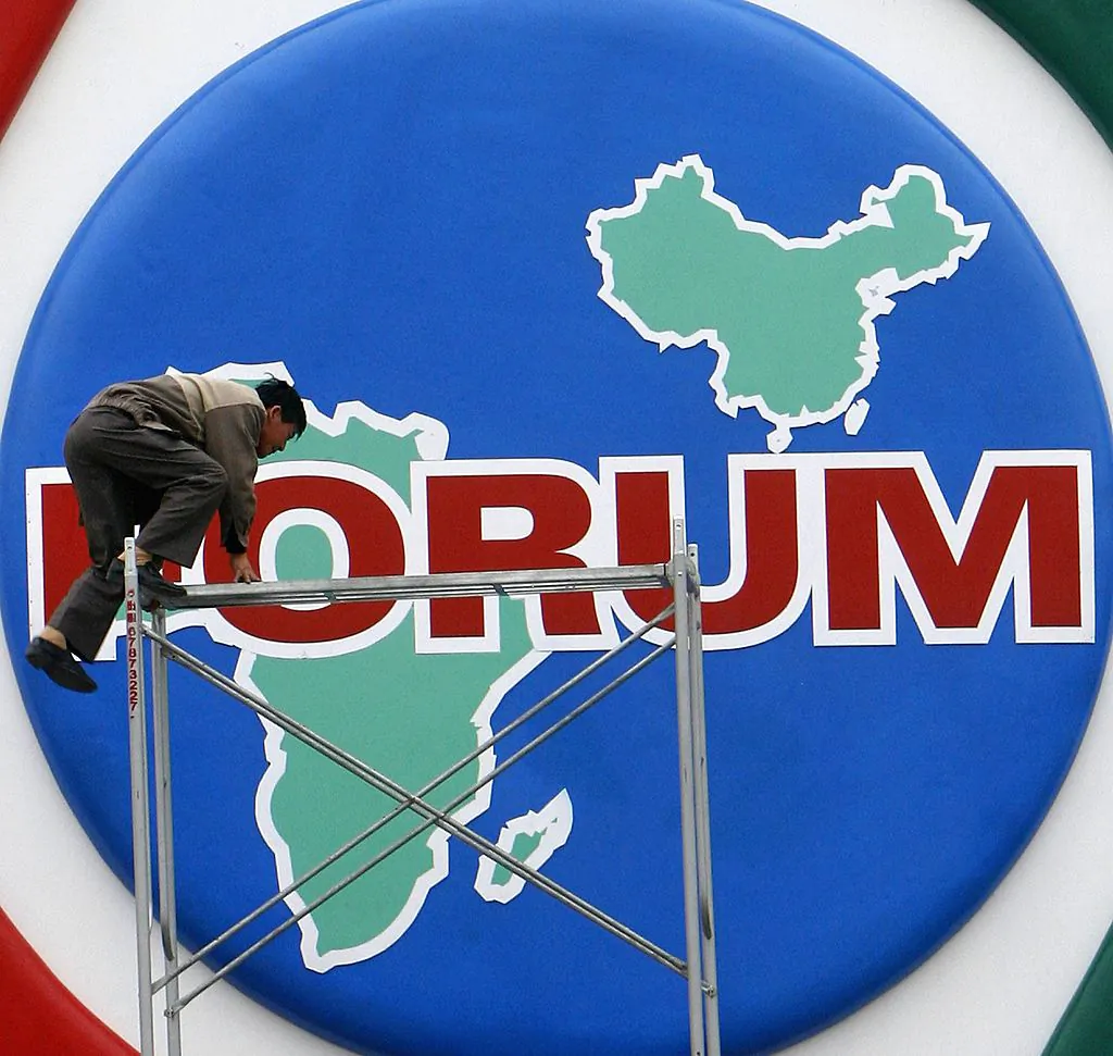 A worker installing decorations promoting the Beijing Summit of the Forum on China–Africa Cooperation at Tiananmen Square in Beijing on Oct. 27, 2006. (China Photos/Getty Images)