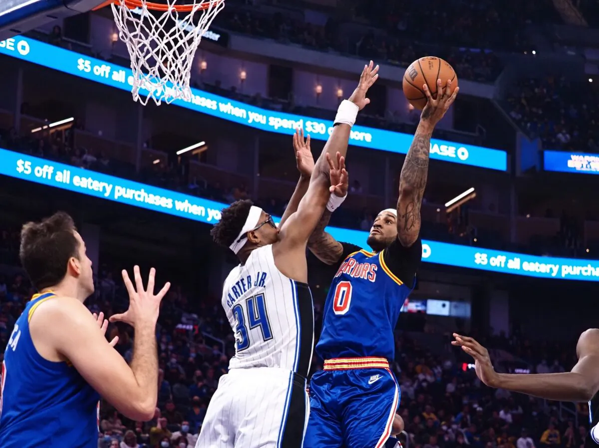 Golden State Warriors guard Gary Payton II (0) scores a basket against Orlando Magic during an NBA game at Chase Center, in San Francisco, Calif., on Dec. 6, 2021. (Kelley L Cox/USA TODAY Sports via Field Level Media)