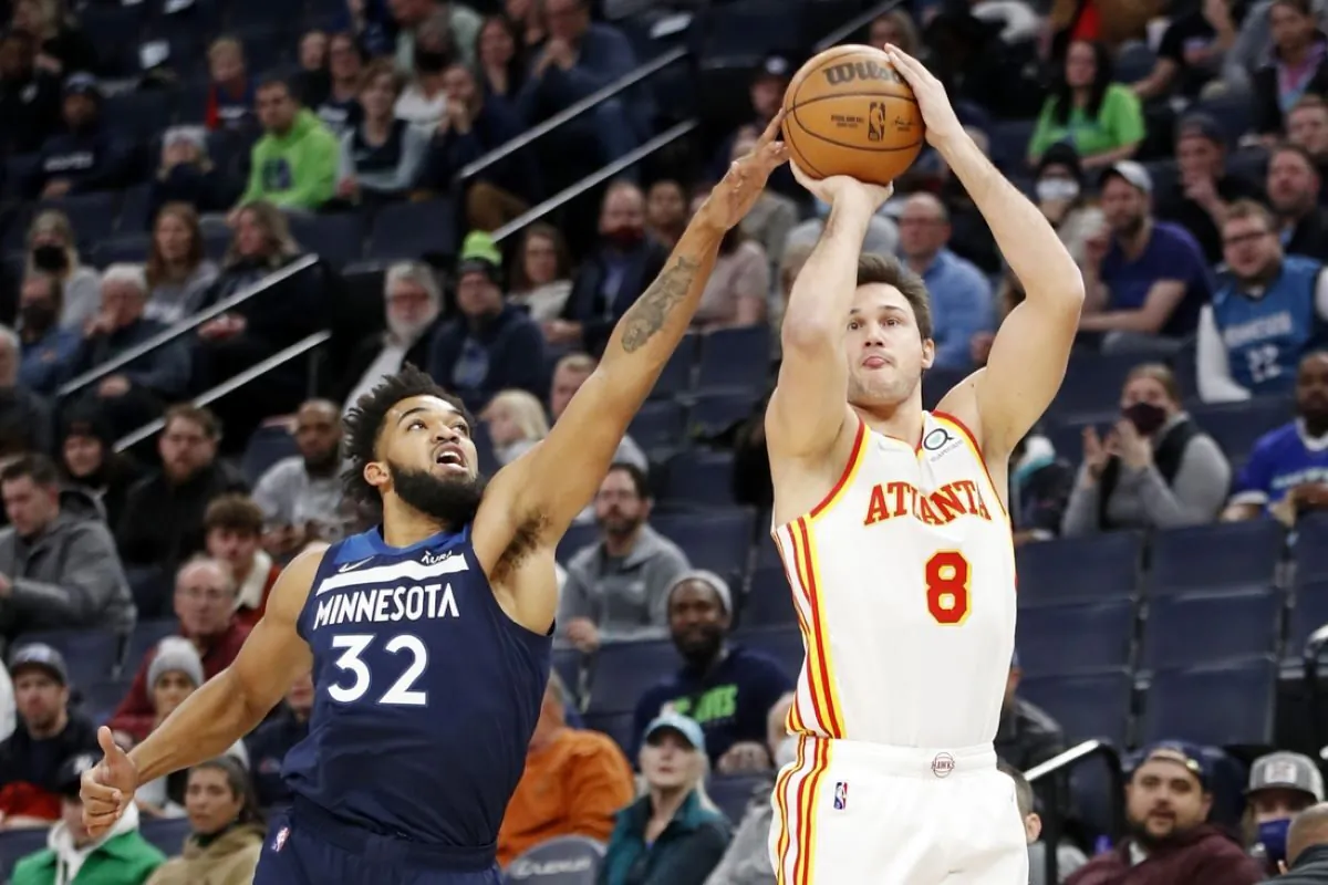 Atlanta Hawks forward Danilo Gallinari (8) shoots as Minnesota Timberwolves center Karl-Anthony Towns (32) tries tro defend him in the first quarter at Target Center in  Minneapolis, on Dec. 6, 2021.(Bruce Kluckhohn/USA TODAY Sports via Field Level Media)