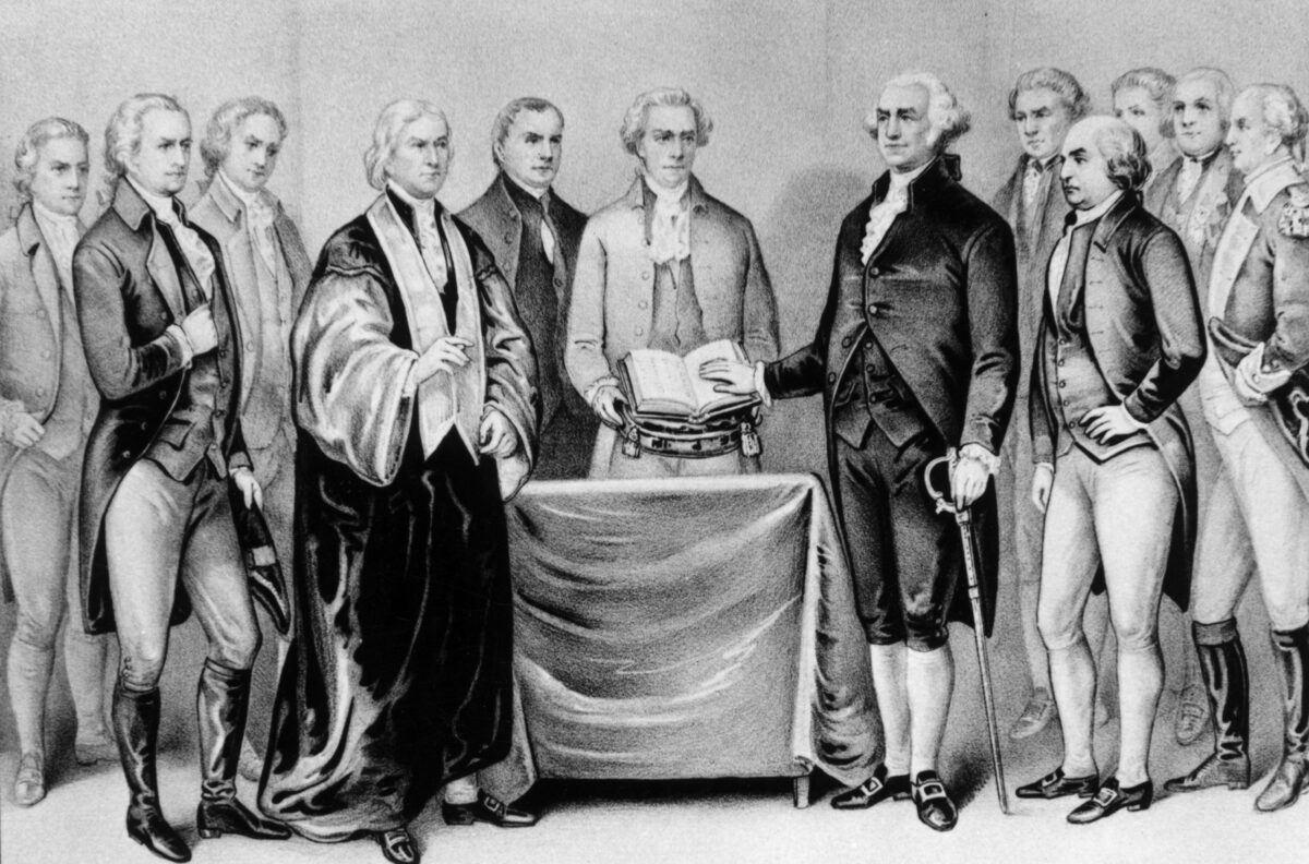 The inauguration of George Washington as the first president of the United States in 1789. Also present are (from left) Alexander Hamilton, Robert R. Livingston, Roger Sherman, Mr. Otis, Vice President John Adams, Baron Von Steuben, and General Henry Knox.  Original Artwork: Printed by Currier & Ives.  (MPI/Getty Images)