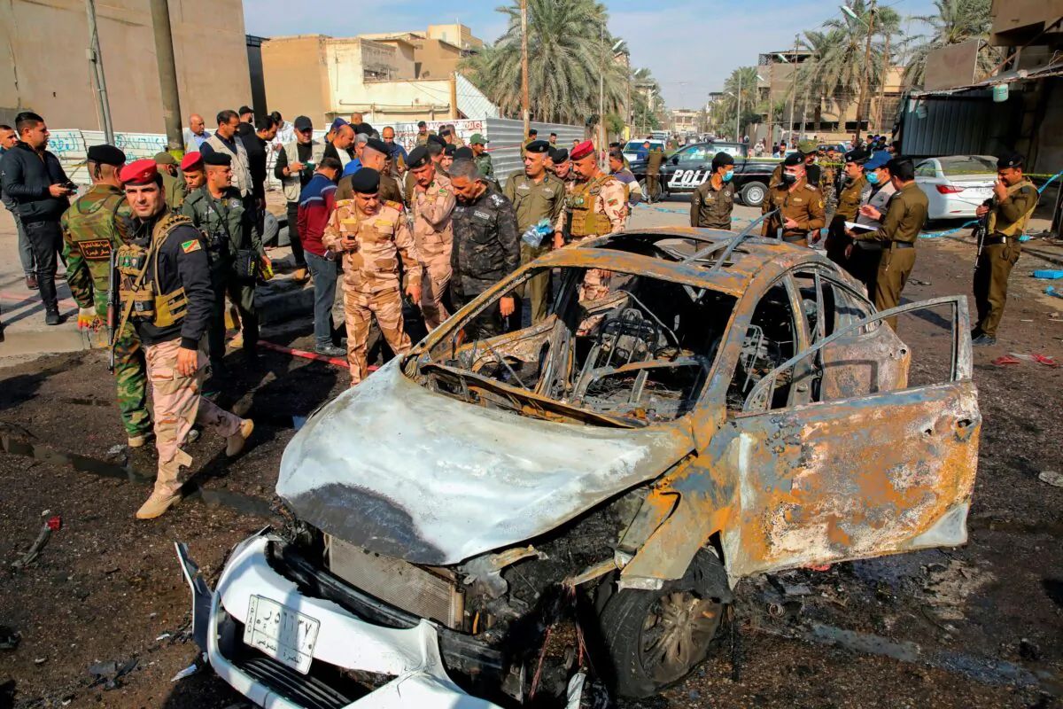 Iraqi security forces inspect the site of an explosion in Basra, Iraq, on Dec. 7, 2021. (Nabil al-Jurani/AP Photo)