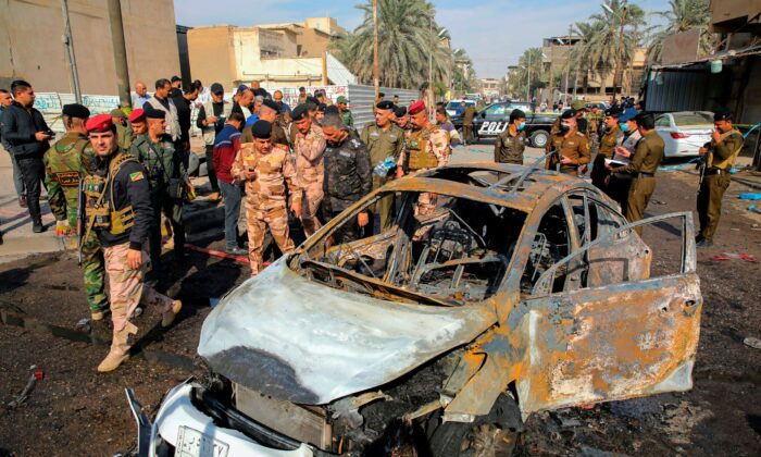 Iraqi security forces inspect the site of an explosion in Basra, Iraq, on Dec. 7, 2021. (Nabil al-Jurani/AP Photo)