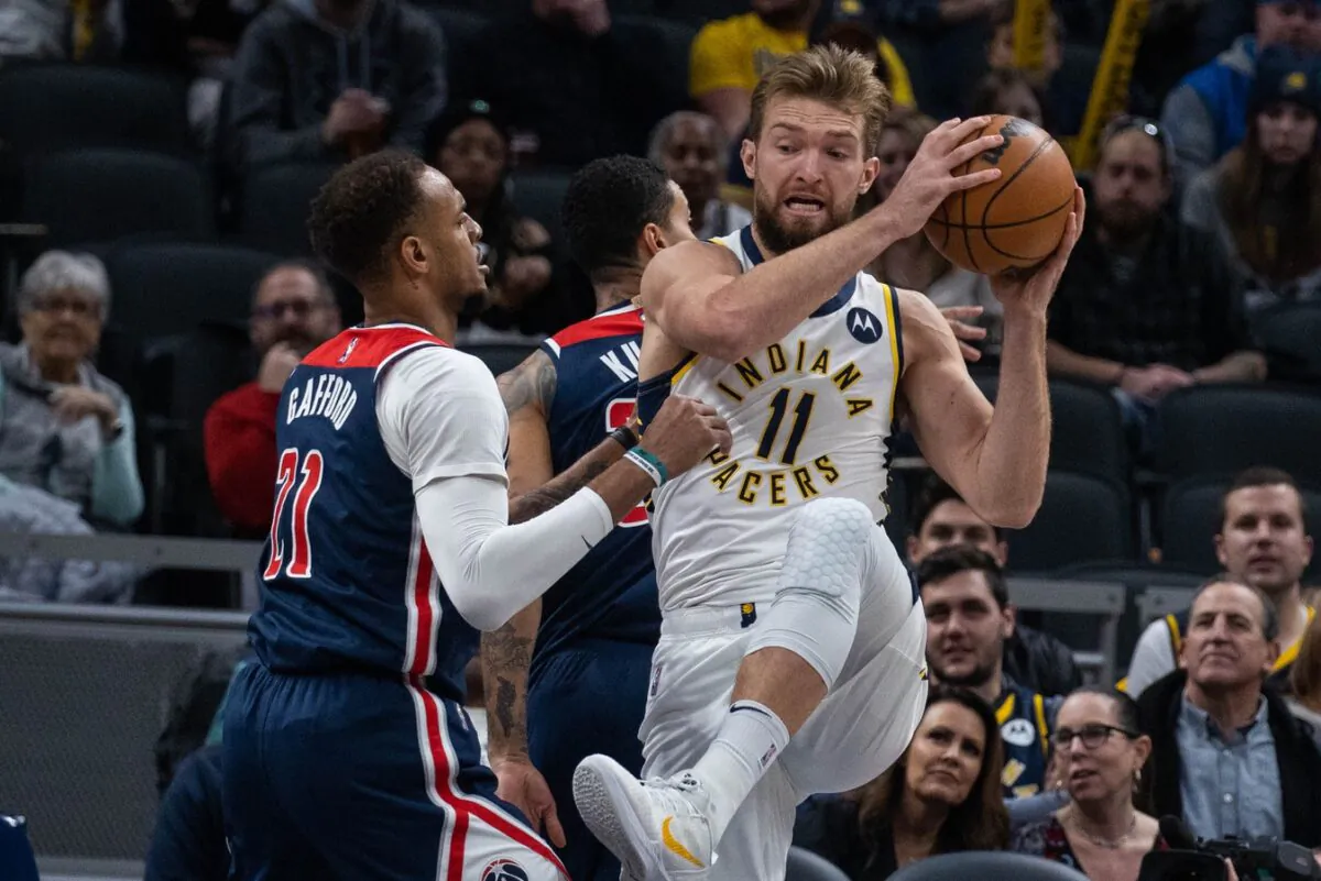Indiana Pacers forward Domantas Sabonis (11) rebounds the ball over Washington Wizards center Daniel Gafford (21) in the first quarter at Gainbridge Fieldhouse in Indianapolis, on Dec. 6, 2021. (Trevor Ruszkowski/USA TODAY Sports via Field Level Media)