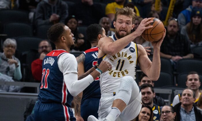 Indiana Pacers forward Domantas Sabonis (11) rebounds the ball over Washington Wizards center Daniel Gafford (21) in the first quarter at Gainbridge Fieldhouse in Indianapolis, on Dec. 6, 2021. (Trevor Ruszkowski/USA TODAY Sports via Field Level Media)