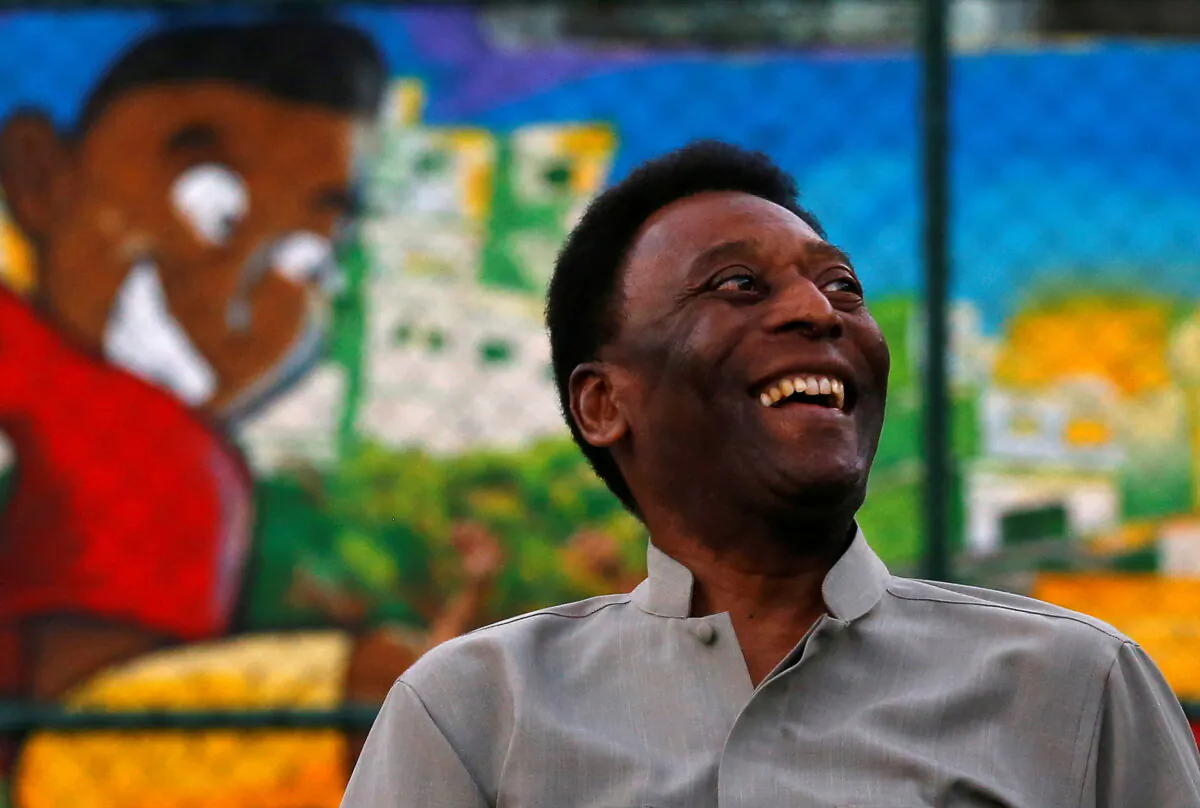 Brazilian soccer legend Pele laughs during the inauguration of a refurbished soccer field at the Mineira slum in Rio de Janeiro, on Sept. 10, 2014. (Ricardo Moraes/Reuters)