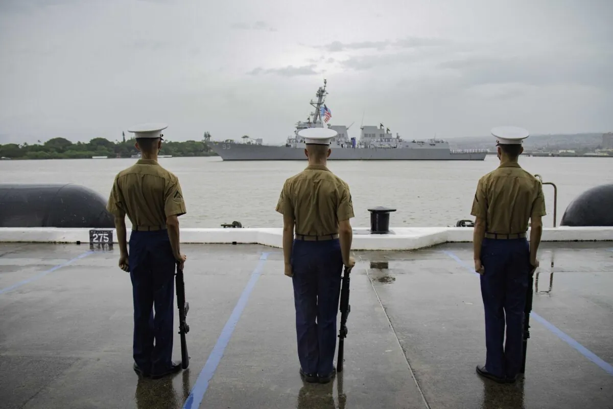 Marines stand at attention as the sailors render honors to the USS Arizona Memorial during the 80th Anniversary Pearl Harbor Remembrance on Dec. 7, 2021. (U.S. Navy photo by Mass Communication Specialist 3rd Class Jeremy Lemmon Jr.)