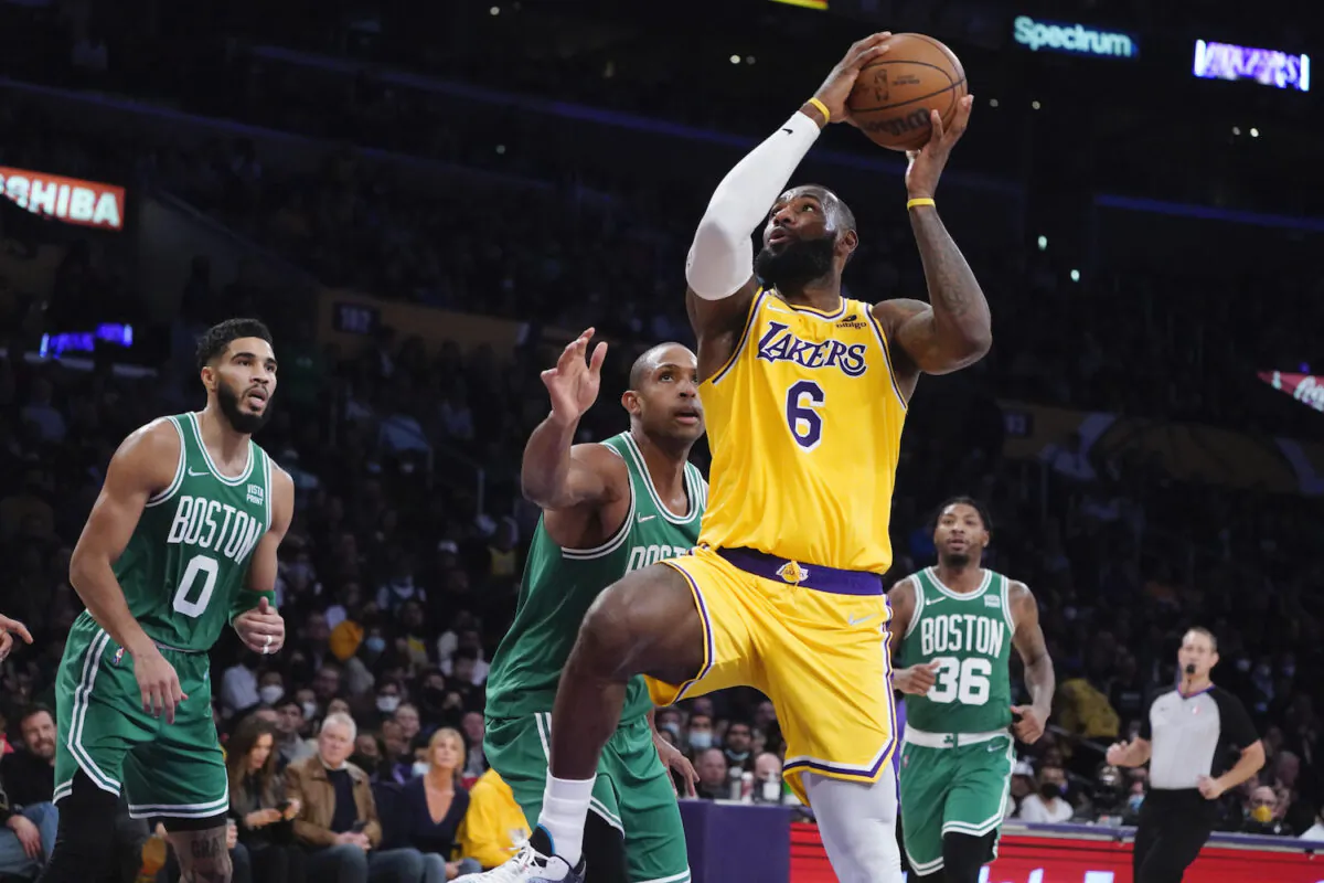 Los Angeles Lakers forward LeBron James (6) drives past Boston Celtics center Al Horford, center, during the second half of an NBA basketball game in Los Angeles on Dec. 7, 2021. (AP Photo/Marcio Jose Sanchez)