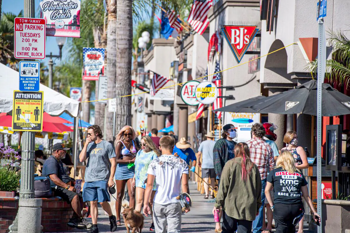 People browse restaurants and shops in downtown Huntington Beach, Calif., on July 16, 2020. (Robin Beck/AFP via Getty Images)