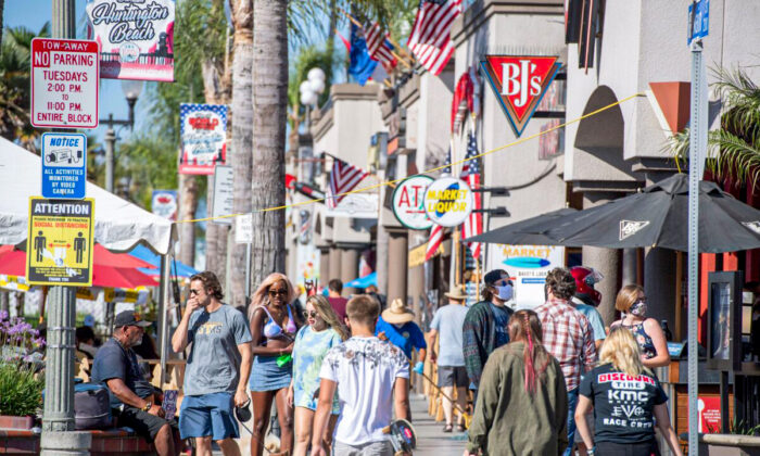 People browse restaurants and shops in downtown Huntington Beach, Calif., on July 16, 2020. (Robin Beck/AFP via Getty Images)