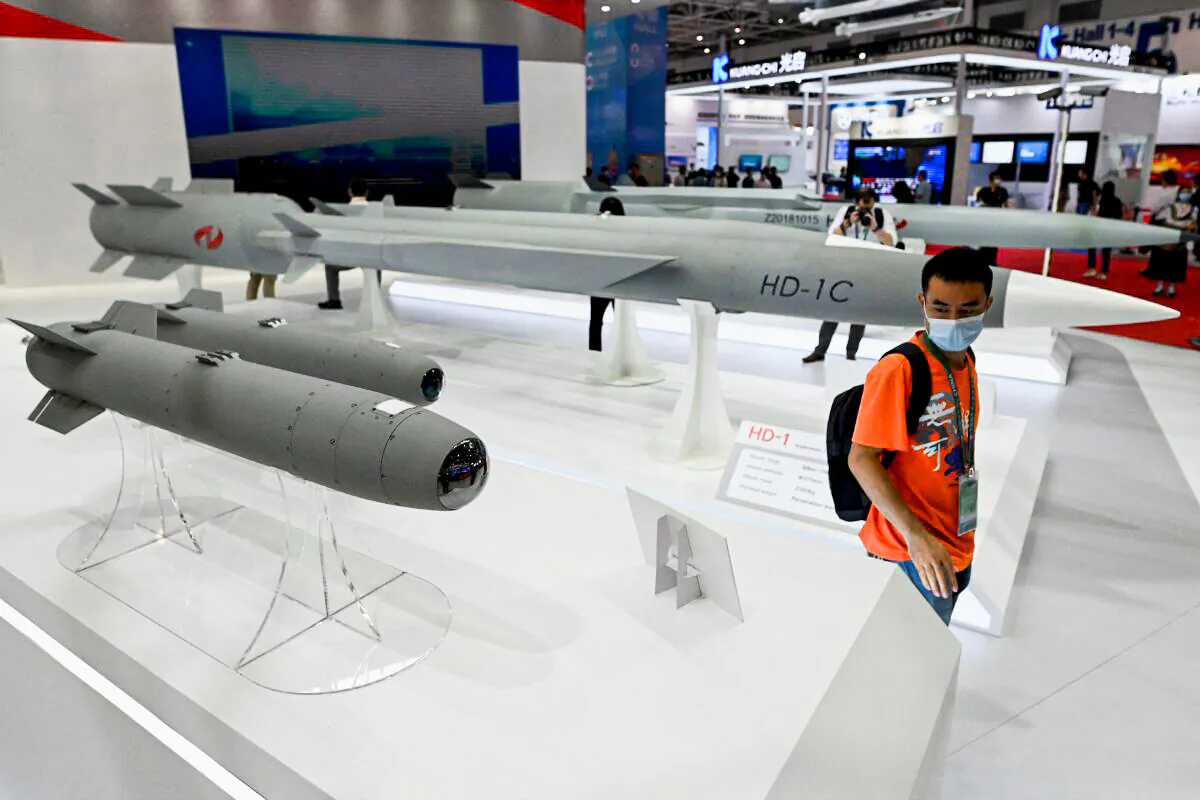 A man walks among supersonic cruise missiles at the 13th China International Aviation and Aerospace Exhibition in Zhuhai in southern China's Guangdong province on Sept. 28, 2021. (Noel Celis/AFP via Getty Images)