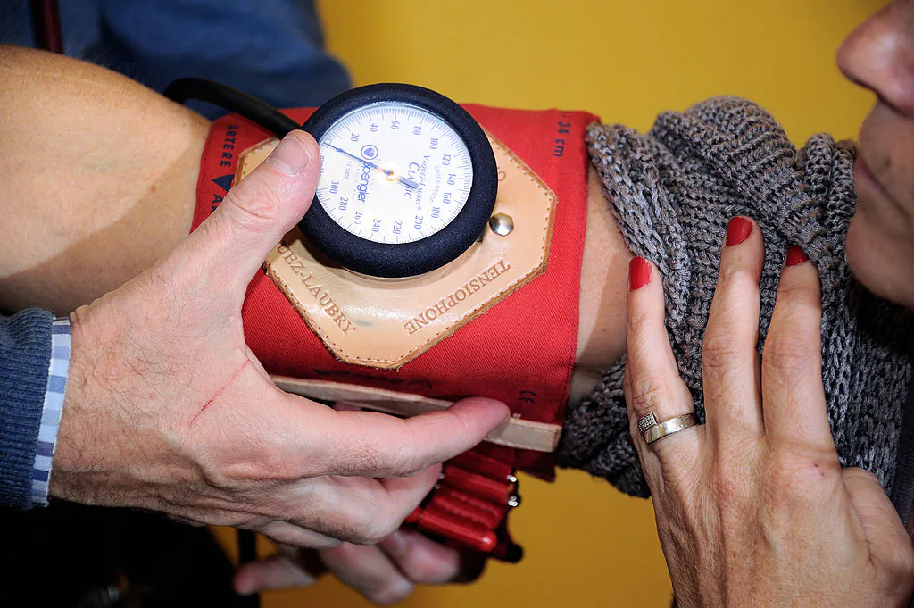 A doctor (R) examines a patient on September 25, 2012 in Godewaersvelde, northern France, during a medical check-up. (Philippe Huguen/AFP/GettyImages)