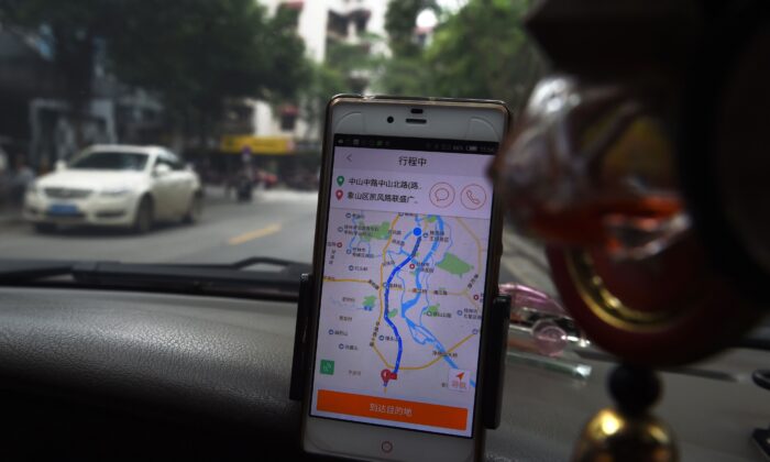  A taxi driver uses the Didi Chuxing app while driving along a street in Guilin, in China's southern Guangxi region on May 13, 2016. (Greg Baker/AFP via Getty Images)
