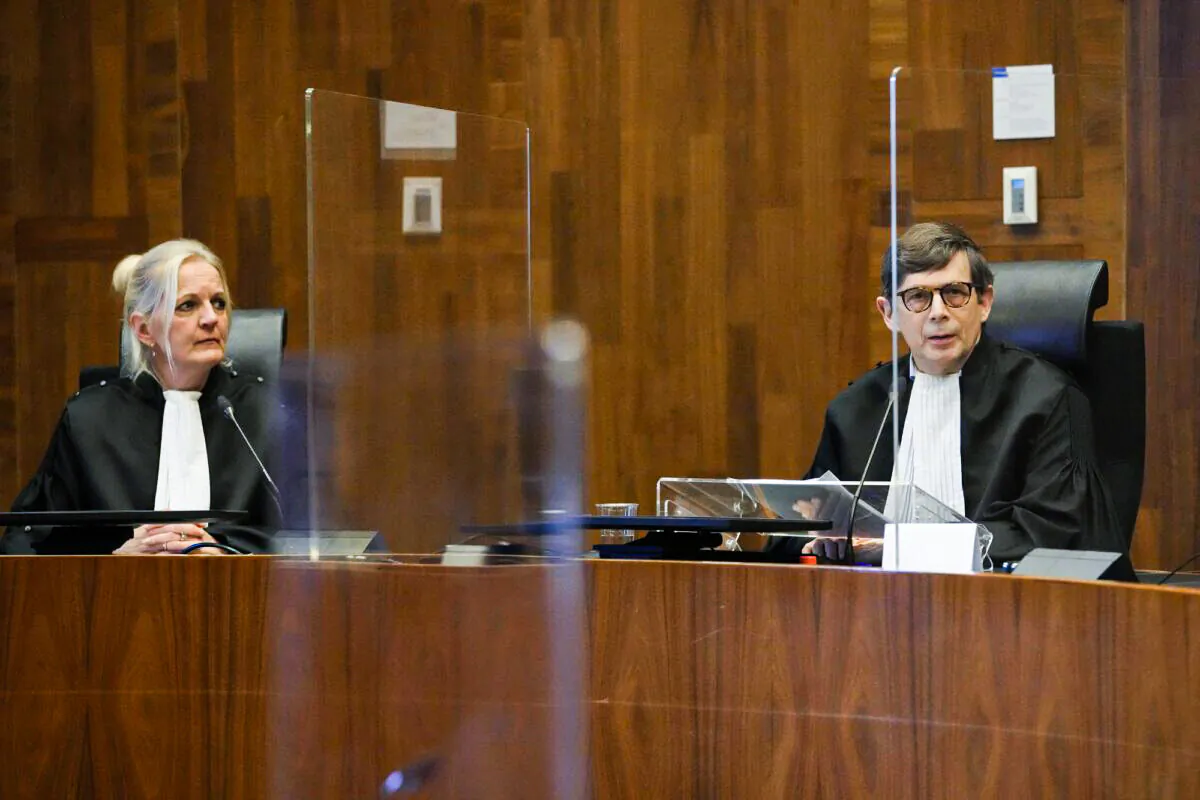 Presiding judge Boele, right, prepares to read the verdict in an appeals court in The Hague, Netherlands, on Dec. 7, 2021. (Peter Dejong/AP Photo)