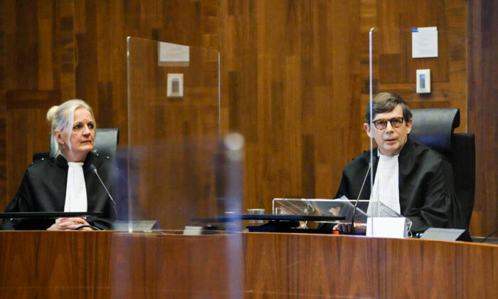 Presiding judge Boele, right, prepares to read the verdict in an appeals court in The Hague, Netherlands, on Dec. 7, 2021. (Peter Dejong/AP Photo)